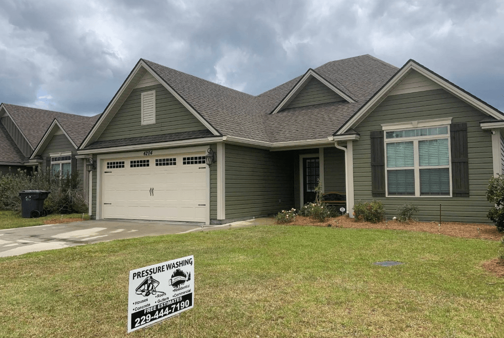 Valdosta Pressure Solutions yard sign listing residential and commercial services